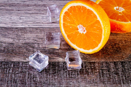 Orange and ice. Fresh ice juice. Fruity freshness of orange. Summer drink with orange juice ice.の写真素材