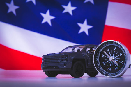 Traveling by car in the USA. Moving to America. Tourists by car. American roads. Compass, maps and usa flag.の写真素材