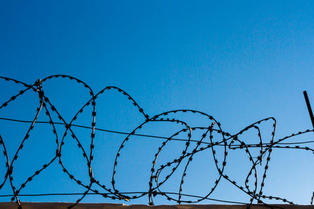 Barbed wire on the prison fence. A closed prison. Security concept. Forbidden territory..の写真素材
