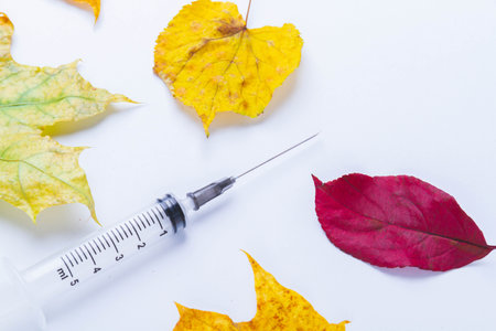 Autumn vaccination of population. Syringe in autumn leaves. Vaccination in autumn. New vaccine..の写真素材