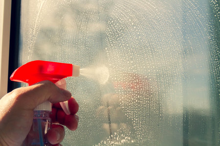 Window washing. Cleaning the window with a brush and foam. The concept of cleanliness and cleaning..の写真素材