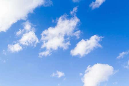 White airy beautiful clouds in a bright blue sky. Clear sunny weather. The concept of environmental safety and cleanliness..の写真素材