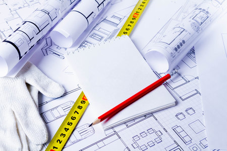 The builder records the construction costs. Construction plan approval. Notepad in the hands of the foreman..の写真素材