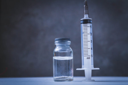 Time for vaccination. Watch and syringe with vaccine. Date and time of preventive vaccinations to population..の写真素材
