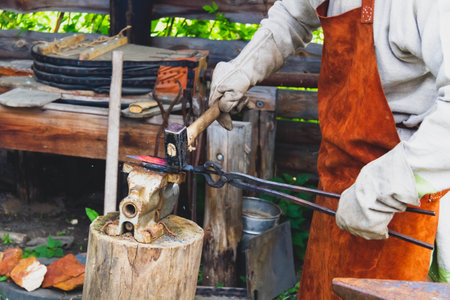 A blacksmith forges iron. Blacksmith's workshop. Blacksmith's anvil and hammer..の写真素材