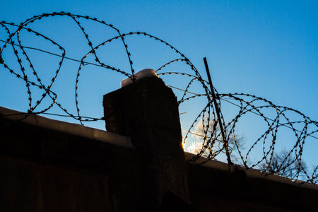 Barbed wire on the prison fence. A closed prison. Security concept. Forbidden territory..の写真素材