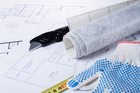 Laying flooring. Linoleum, a knife and a house plan on the builder's table. Taking measurements for laying the floor..の写真素材