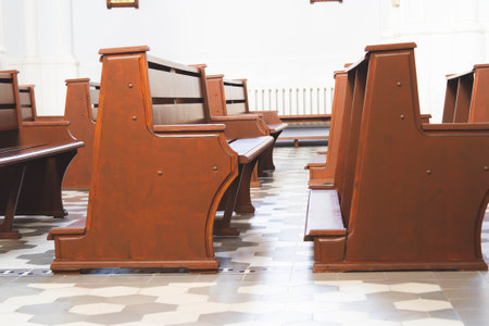 People pray in the church. Church parish. Believers sit on benches in the hall. Prayer time.の写真素材