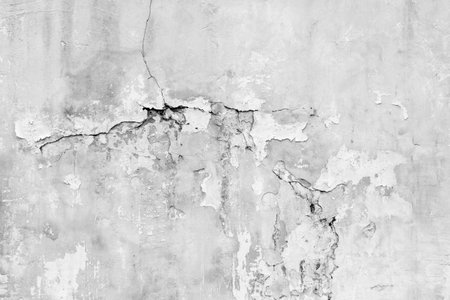 Old wall with deep cracks. Grunge gray color texture. Destruction on the surface of the wall..の写真素材