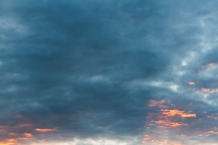 Beautiful sunset sky in dark shades. The sunset breaks through the black clouds..の写真素材