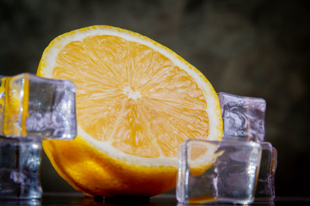 Lemons and ice. Ice cubes and sliced lemon wedges. Lemonade preparation. Copyspace.の写真素材