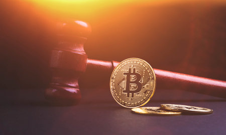 bitcoin judgment. Cryptocurrency fraud. Money theft while exchanging currencies. The conviction of the accused of stealing bitcoin. Judge and coin.の写真素材