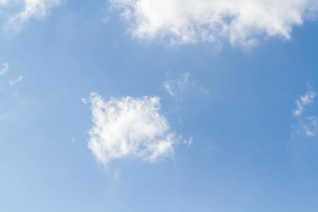 White airy beautiful clouds in a bright blue sky. Clear sunny weather. The concept of environmental safety and cleanliness..の写真素材