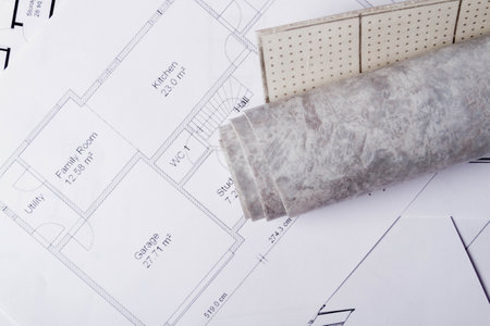 Laying flooring. Linoleum, a knife and a house plan on the builders table. Taking measurements for laying the floor..の写真素材