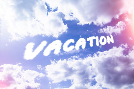 Vacation. Text from clouds in sky in bright sunlight..の写真素材