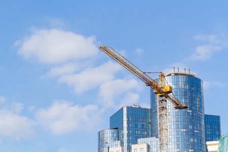 Construction in metropolis. Construction crane on background of business center in city center..の写真素材