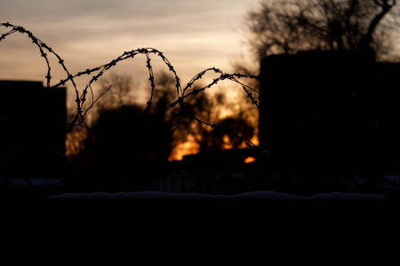 Barbed wire on the prison fence. A closed prison. Security concept. Forbidden territory..の写真素材
