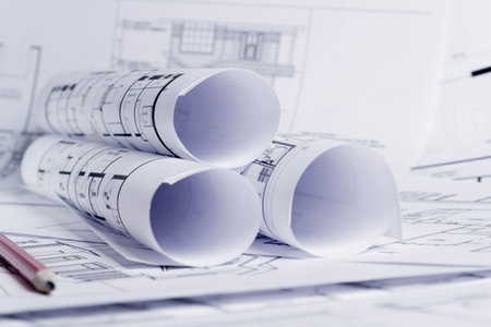 Construction plan. Scheme drawing rolled up in a roll. Home renovation planning..の写真素材