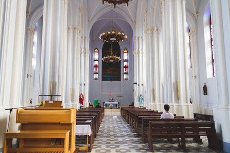 People pray in the church. Church parish. Believers sit on benches in the hall. Prayer time.の写真素材