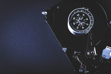 Searching for information on HDD. Compass and computer hard drive. Search for cryptocurrency. Bitcoin mining..の写真素材