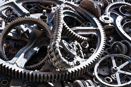 Metal gears background. Old and rusty spare parts for industrial machines in a landfill..の写真素材