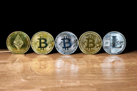 Cryptocurrencies lined up in a row on a contrastingの写真素材