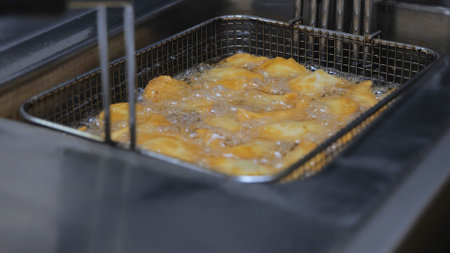 The process of cooking in the kitchen. Pasties with meat fried in sunflower oil, deep-fried. Fast food, junk food. Tatar, Caucasian, Greek cuisine.の写真素材
