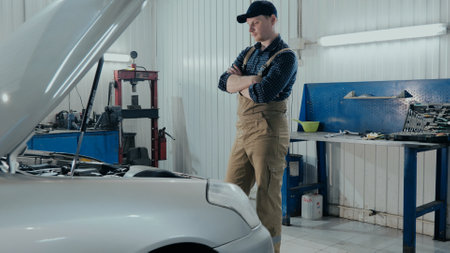 An auto mechanic inspects a car for damage. A mechanic diagnoses a car engine. Old car repair