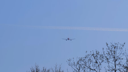 Airliner with passengers on the blue sky. The plane flies in the sky. The plane takes off against a...
