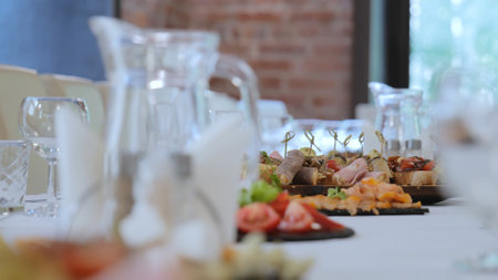 A beautiful festive table covered with a variety of food. Food and drinks on the festive table in the restaurant on birthdays, weddings. Beautifully decorated banquet table with appetizers.の写真素材