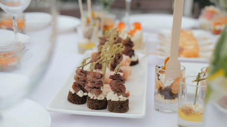 A beautiful festive table covered with a variety of food. Food and drinks on the festive table in...