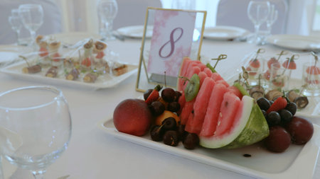 Elegant table setting in a luxurious restaurant. Luxurious banquet tables prepared for the official ceremony. A round table without food is served with plates, napkins, glasses and cutlery.の写真素材