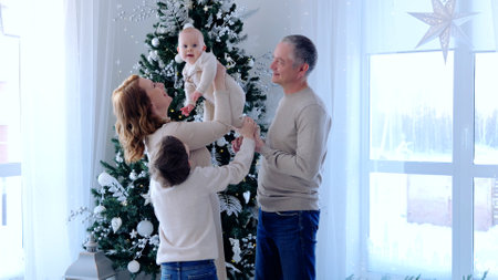 Joyous family comes together around a christmas tree, cherishing the festive season with their...