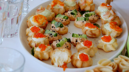Vol au vent pastry shells filled with delicate salmon, shrimp, cucumber, garnished with red caviar...