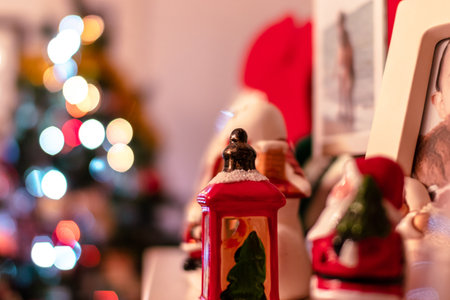 Christmas at home, the decorations. The bokeh of the Christmas tree in the background that brings out the decorations on the shelf, above the fireplace.の写真素材