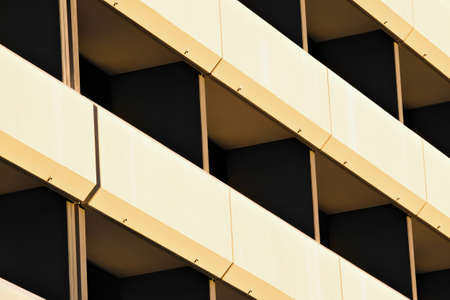 Architectural fragment of modern minimalist building facade, balconies with white metal claddingの写真素材