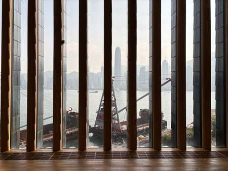 View of Hong Kong Harbor from the glass window. M+ is an art museum located in the West Kowloon...
