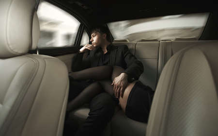 Adult sexy man sitting in car with girlの写真素材