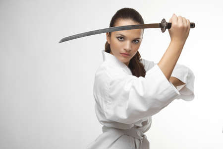 Attractive young sexy women with samurai sword on white backgroundの写真素材