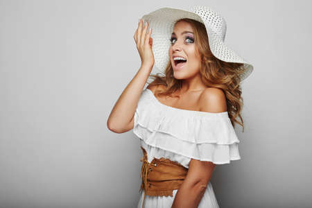 Portrait of beautiful blond woman in white dressの写真素材