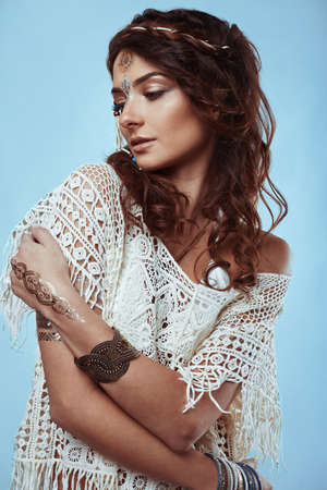 Portrait of beautiful glamor hipster young hippie woman in knitted shirtの写真素材