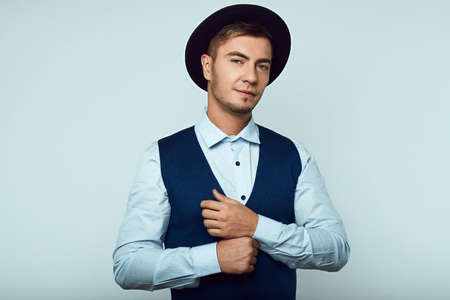 Portrait of beautiful young hipster man wearing hat isolated in studioの写真素材