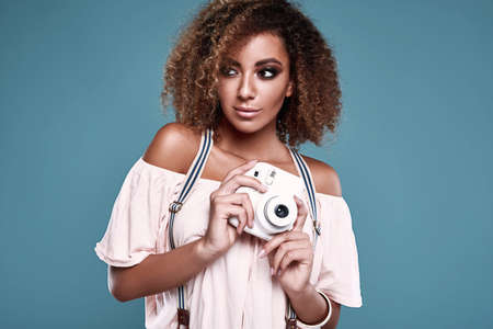 Sensual portrait of glamor elegant black hippy woman model with curly hair and quick camera posing...