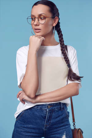 Glamorous fashion portrait of beautiful charming hispanic girl in white t-shirt, jeans and glasses...