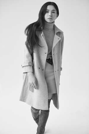 Gorgeous portrait of elegant asian woman in fashionable woolen coat and classic skirt isolated on white backgroundの写真素材