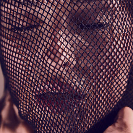 Fashion bright portrait of a beautiful sensual woman in a black veil on her face.の写真素材