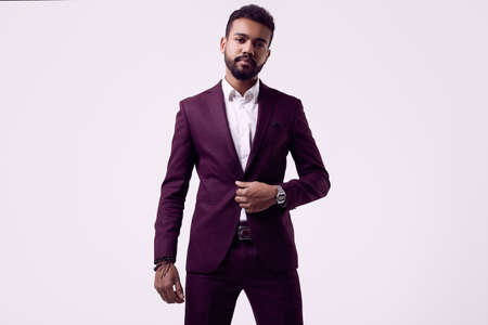 Portrait of cheerful brutal young African American male model in formal fashion suit isolated on white backgroundの写真素材