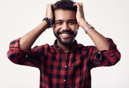 Isolated portrait of fashionable brutal young African American male hipster in red casual shirtの写真素材