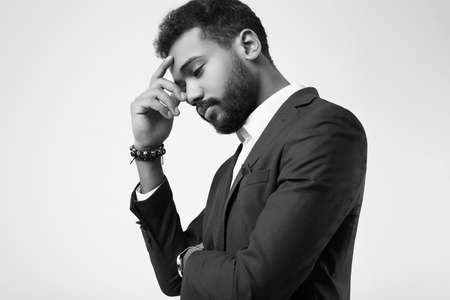 Portrait of cheerful brutal young African American male model in formal fashion suit isolated on white backgroundの写真素材