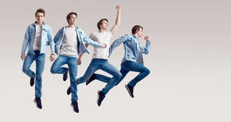 Multiple portrait of a jumping handsome hipster man wearing jeans jacket on white background in studioの写真素材